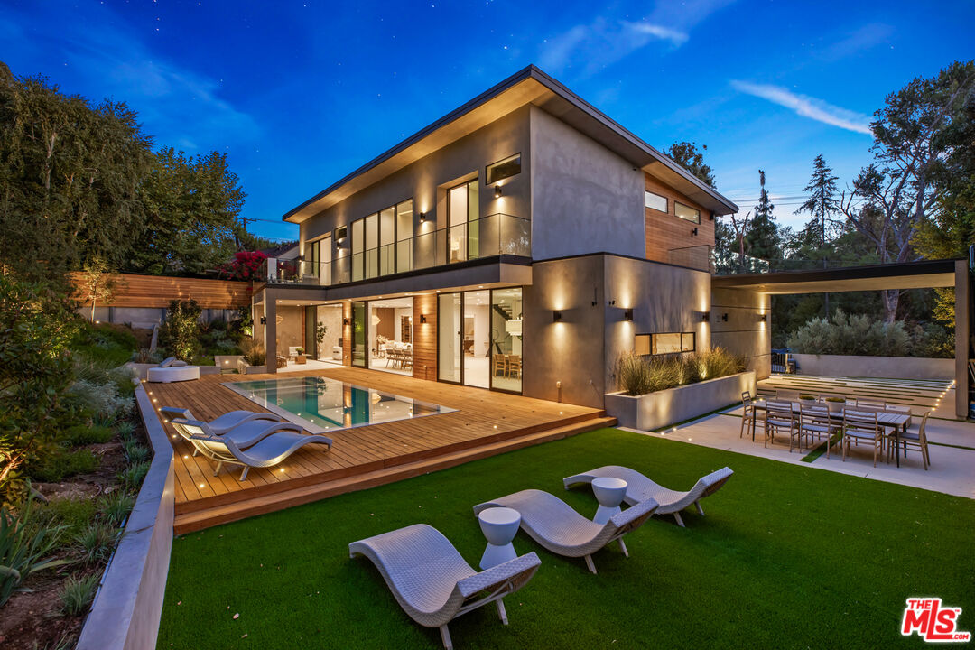 a front view of house with yard and outdoor seating