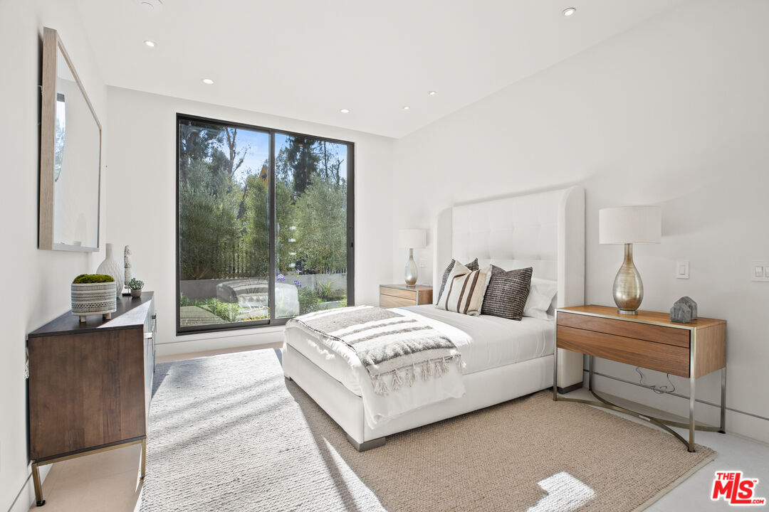 2814 Roscomare Road Los Angeles, CA 90077 - Photo 16 of 35 a bedroom with a bed and large window