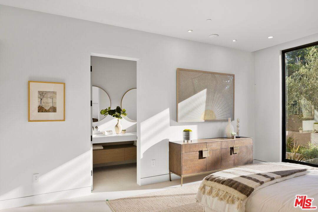 2814 Roscomare Road Los Angeles, CA 90077 - Photo 18 of 35 a bedroom with a bed and a large window