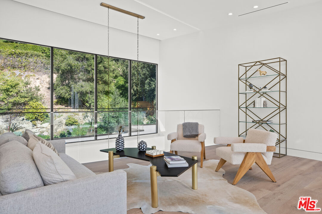 2814 Roscomare Road Los Angeles, CA 90077 - Photo 19 of 35 a living room with furniture and a large window