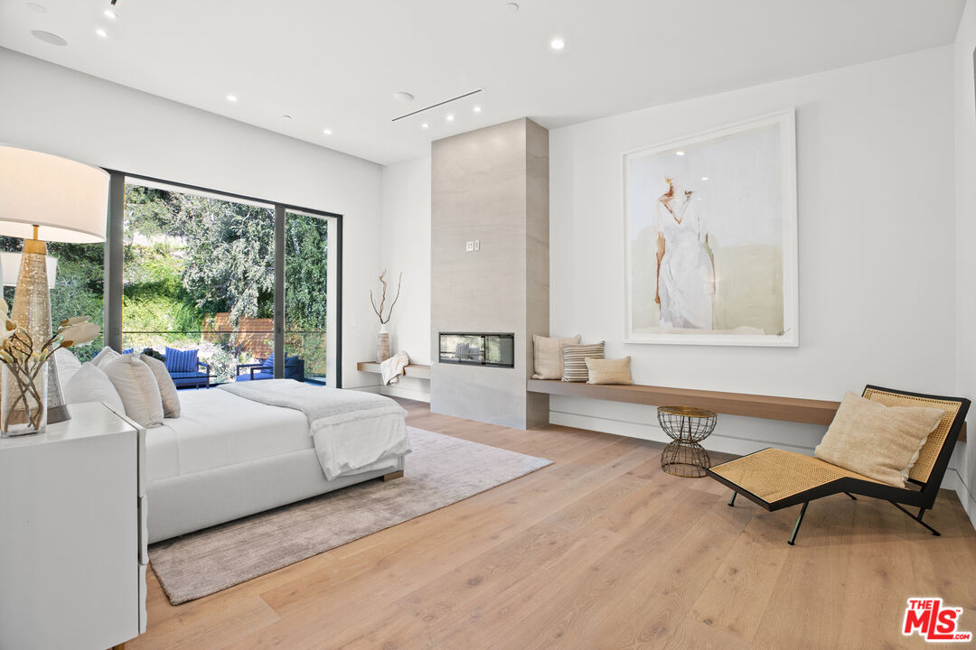 2814 Roscomare Road Los Angeles, CA 90077 - Photo 20 of 35 a bedroom with a bed and a large window