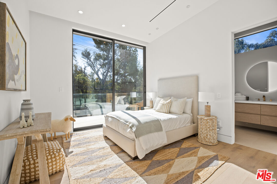 2814 Roscomare Road Los Angeles, CA 90077 - Photo 25 of 35 a bedroom with a large bed and a window