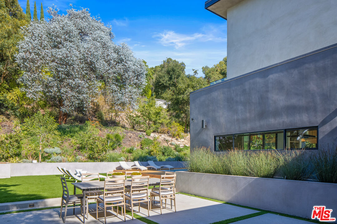 2814 Roscomare Road Los Angeles, CA 90077 - Photo 29 of 35 a view of a patio with table and chairs and potted plants