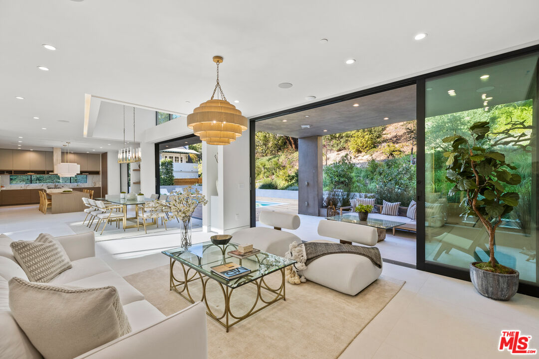 2814 Roscomare Road Los Angeles, CA 90077 - Photo 6 of 35 a living room with patio furniture and a large window