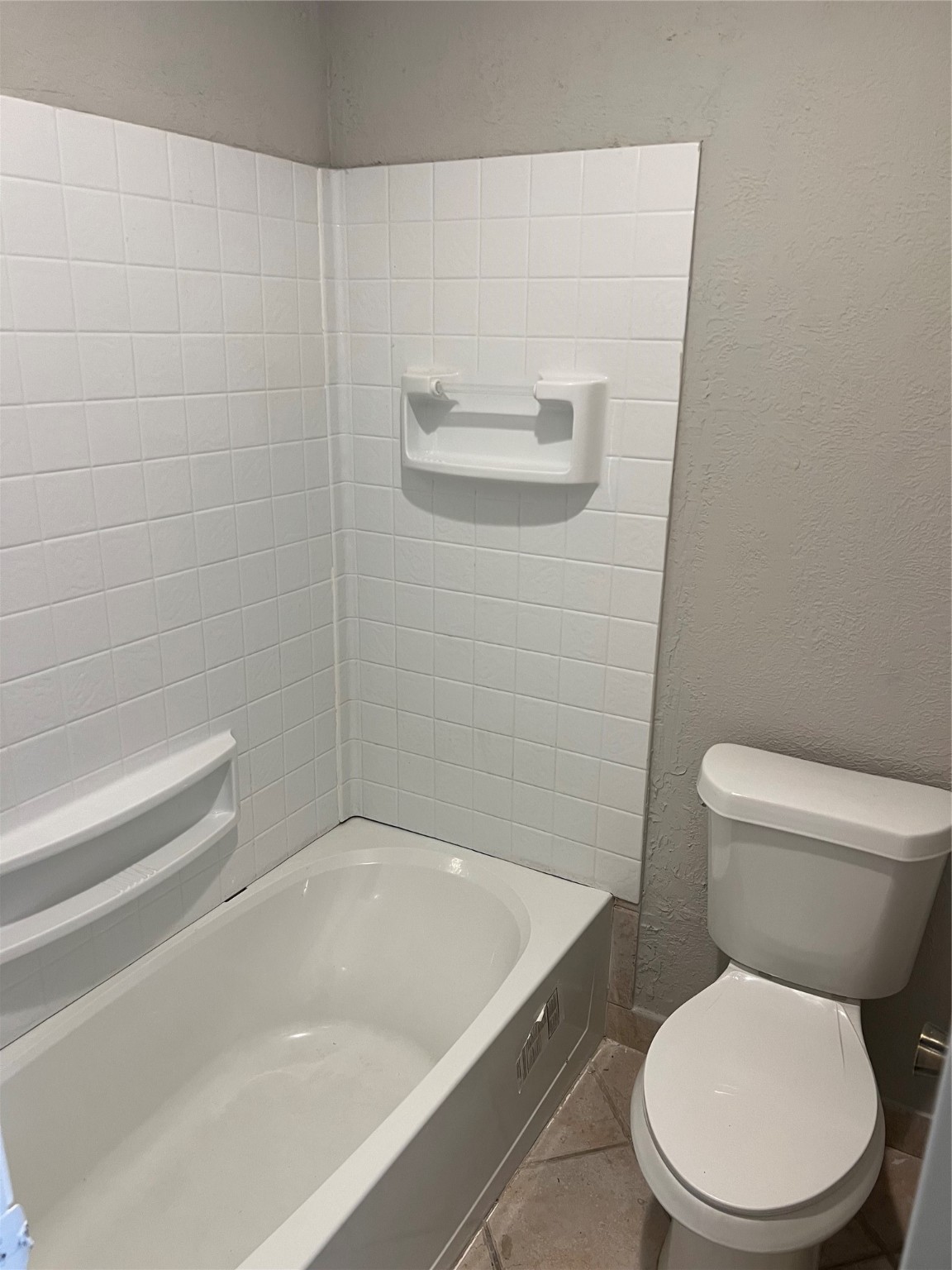 1603 Chestnut Ridge Road Houston, TX 77339 - Photo 11 of 18 a white toilet sitting next to a bath tub