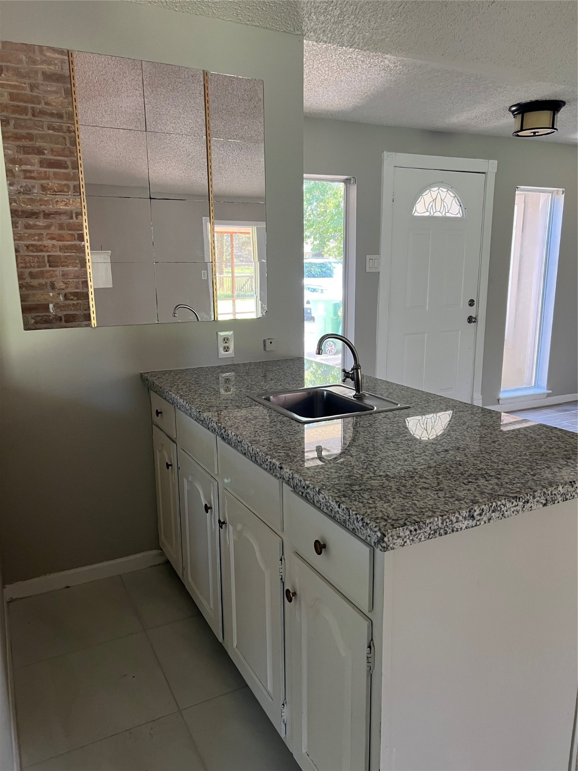 1603 Chestnut Ridge Road Houston, TX 77339 - Photo 15 of 18 a bathroom with a granite countertop sink a mirror and a window
