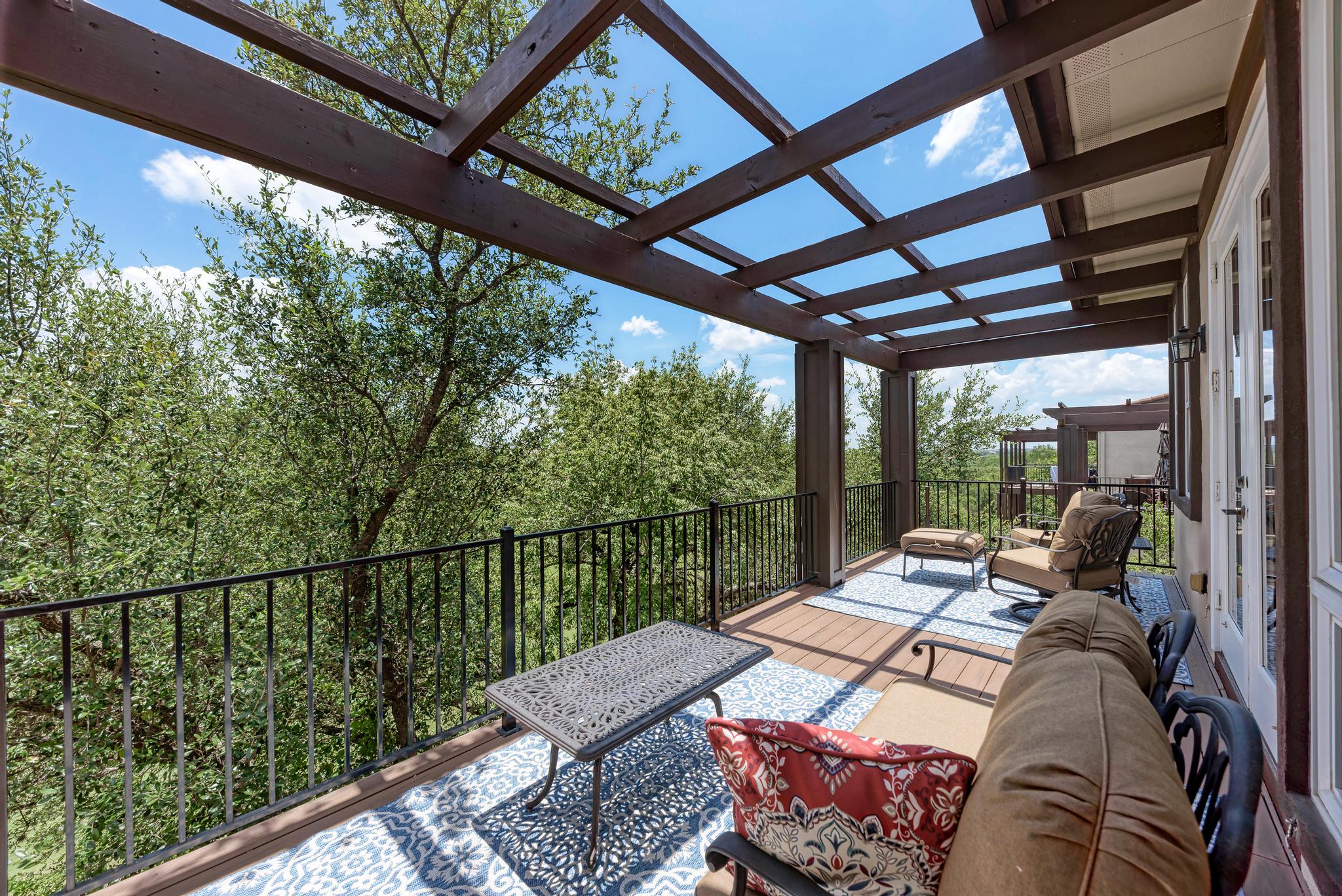2601 North Quinlan Park Road, Unit 506 Austin, TX 78732 - Photo 31 of 39 An inviting deck with an open pergola offers tranquil treetop views.