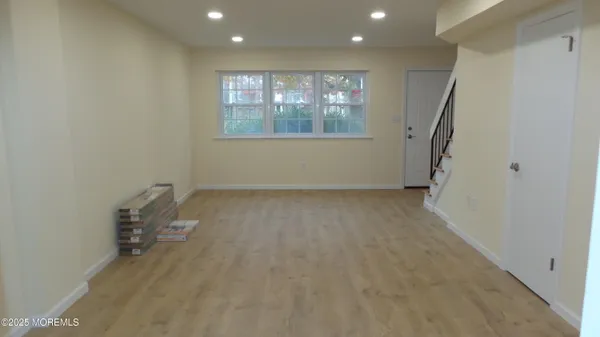a view of room with stairs and wooden floor
