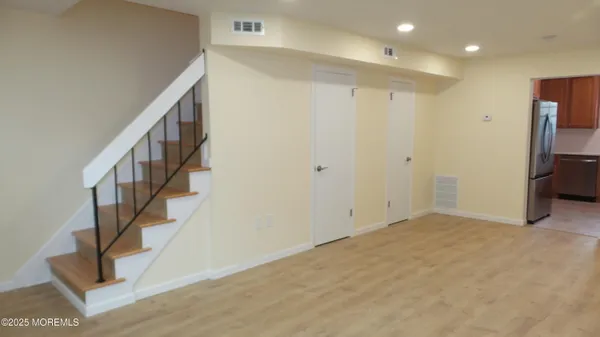 a view of an entryway with wooden floor