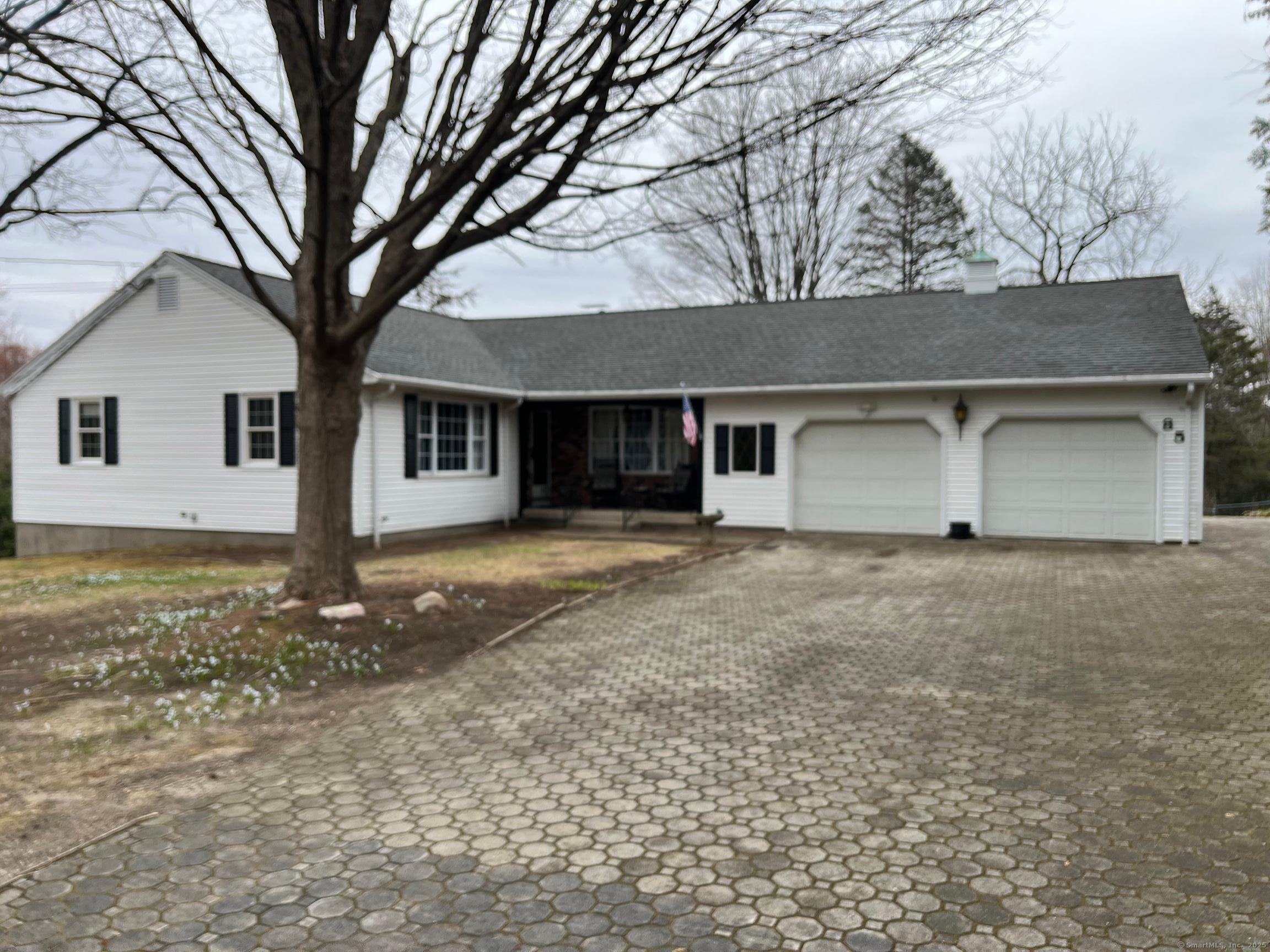 85 Witches Rock Road Bristol, CT 06010 - Photo 1 of 1 a front view of a house with a yard and garage