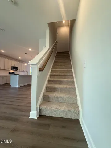 a view of a hallway to rooms