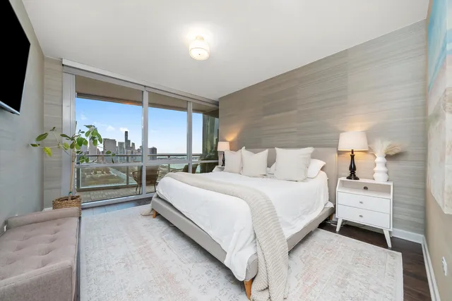 a bedroom with a bed and a flat screen tv