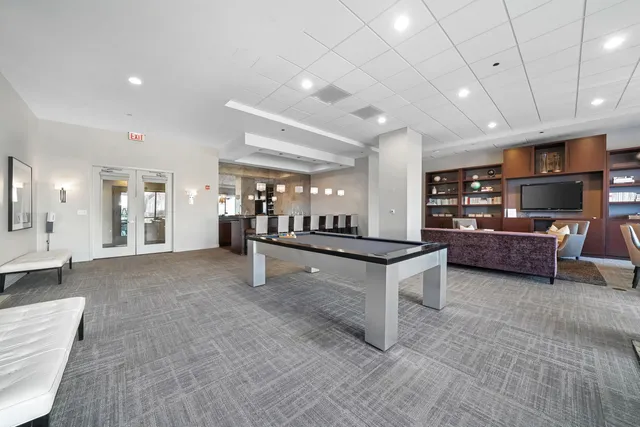 a living room with a couch and a table with wooden floor