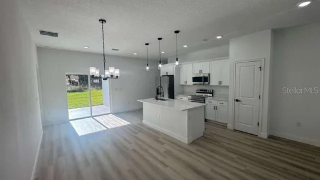 a view of a kitchen with microwave and stove