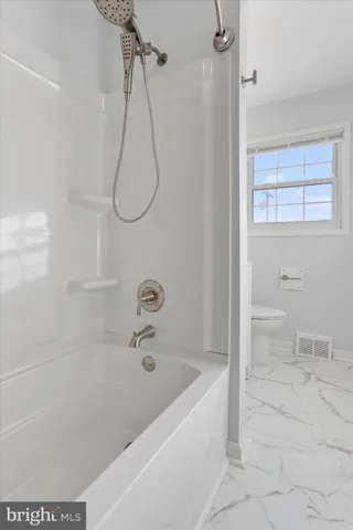 a bathroom with a bath tub and a shower