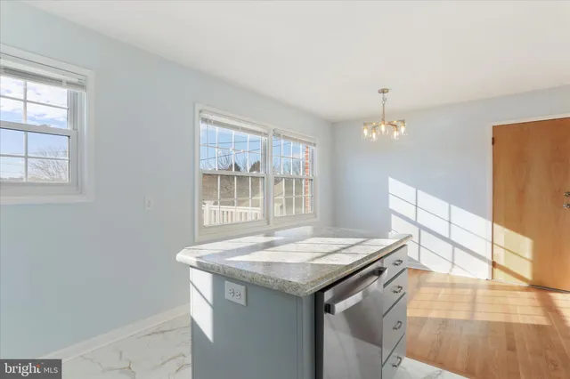 wooden floor fireplace and windows in an empty room