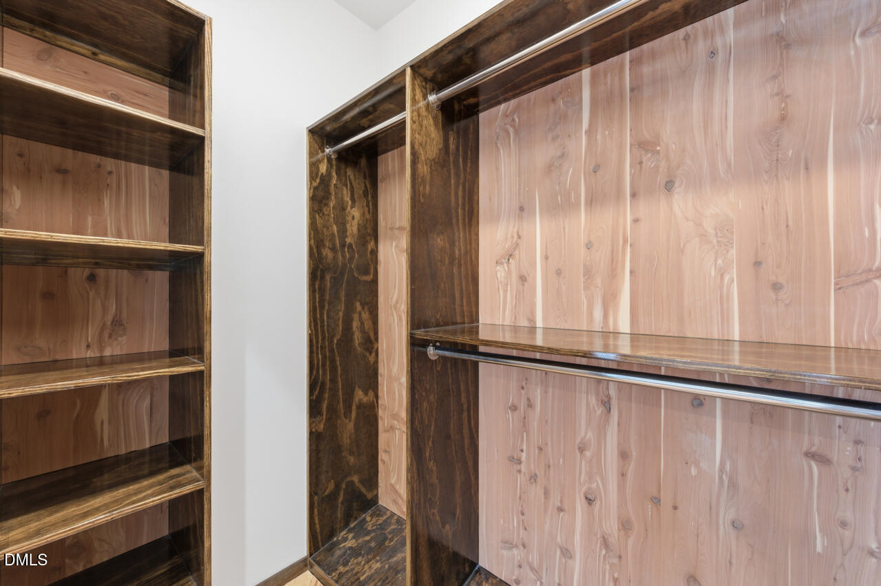 3315 Denada Path Durham, NC 27707 - Photo 35 of 74 a view of walk in closet with wooden floor