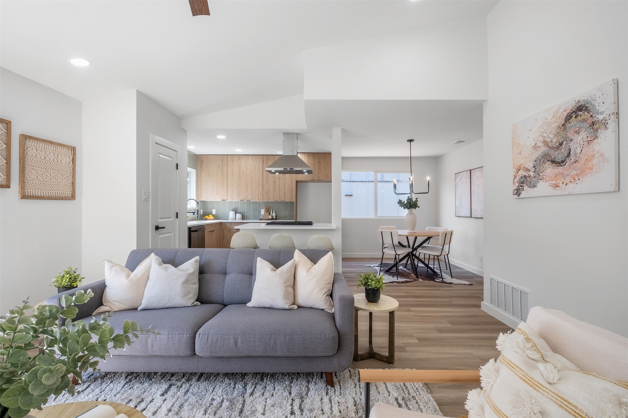 Living room with light wood finished floors and recessed lighting
