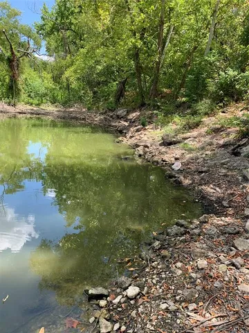 a view of a lake with a yard