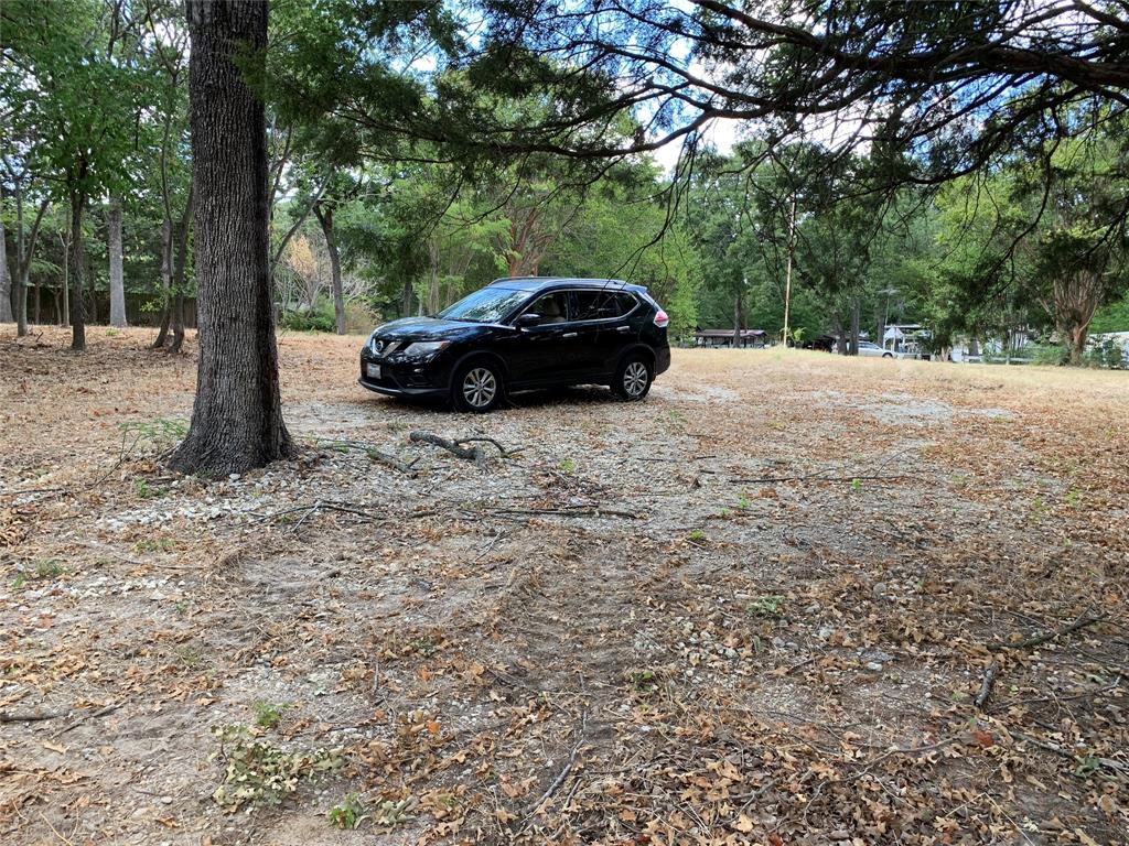 3294 Cedar Bend Drive Wills Point, TX 75169 - Photo 3 of 4 a view of a yard with a car parked in the road