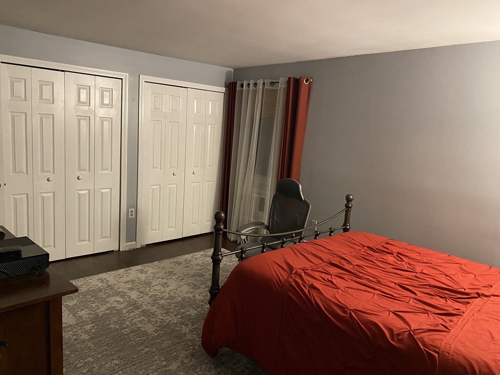 10 Erick Road, Unit 5 Mansfield, MA 02048 - Photo 12 of 24 a bedroom with a bed and a walk in closet