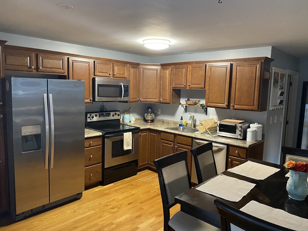 10 Erick Road, Unit 5 Mansfield, MA 02048 - Photo 2 of 24 a kitchen with a refrigerator stove top oven and sink