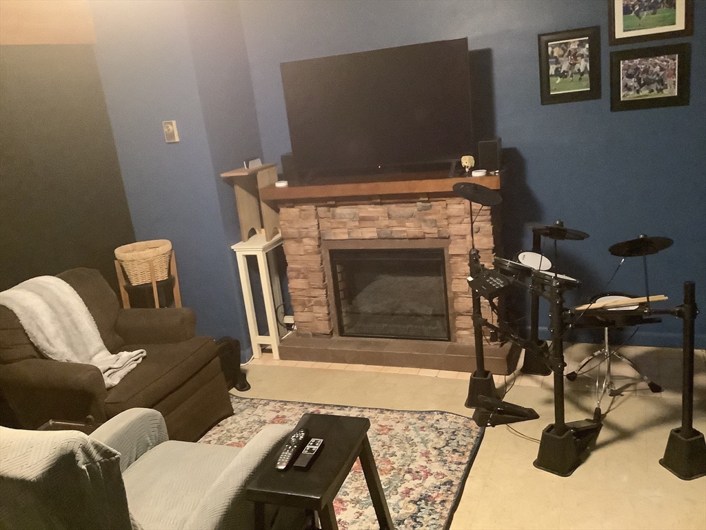 10 Erick Road, Unit 5 Mansfield, MA 02048 - Photo 21 of 24 a living room with furniture and a fireplace