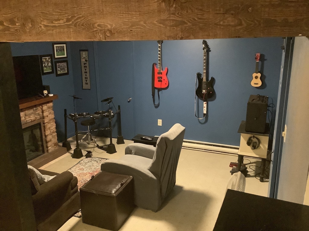 10 Erick Road, Unit 5 Mansfield, MA 02048 - Photo 22 of 24 a dining room with furniture and a flat screen tv