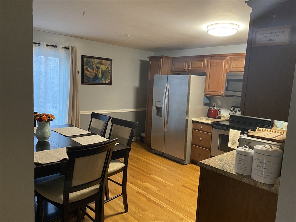 10 Erick Road, Unit 5 Mansfield, MA 02048 - Photo 3 of 24 a kitchen with stainless steel appliances granite countertop a sink stove and refrigerator