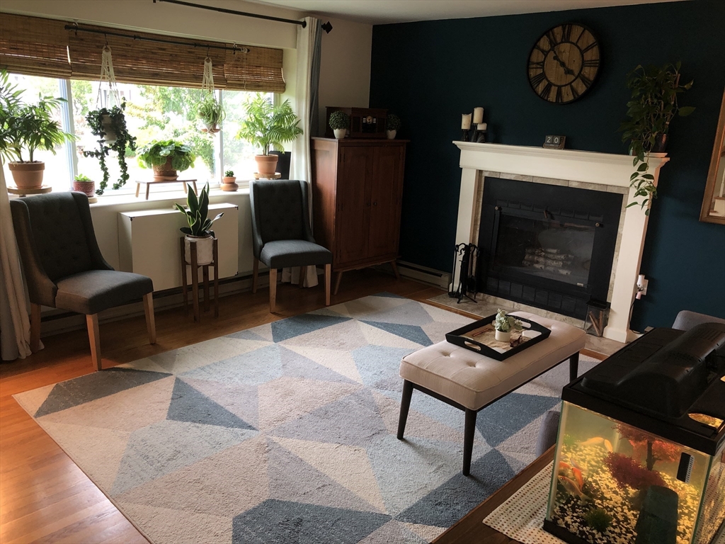 10 Erick Road, Unit 5 Mansfield, MA 02048 - Photo 4 of 24 a living room with furniture a flat screen tv and a fireplace