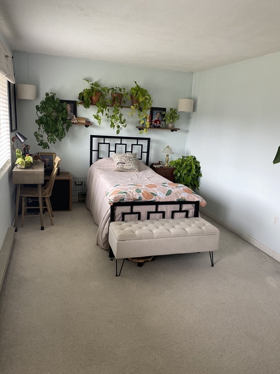 10 Erick Road, Unit 5 Mansfield, MA 02048 - Photo 7 of 24 a bed sitting in a bedroom next to a window