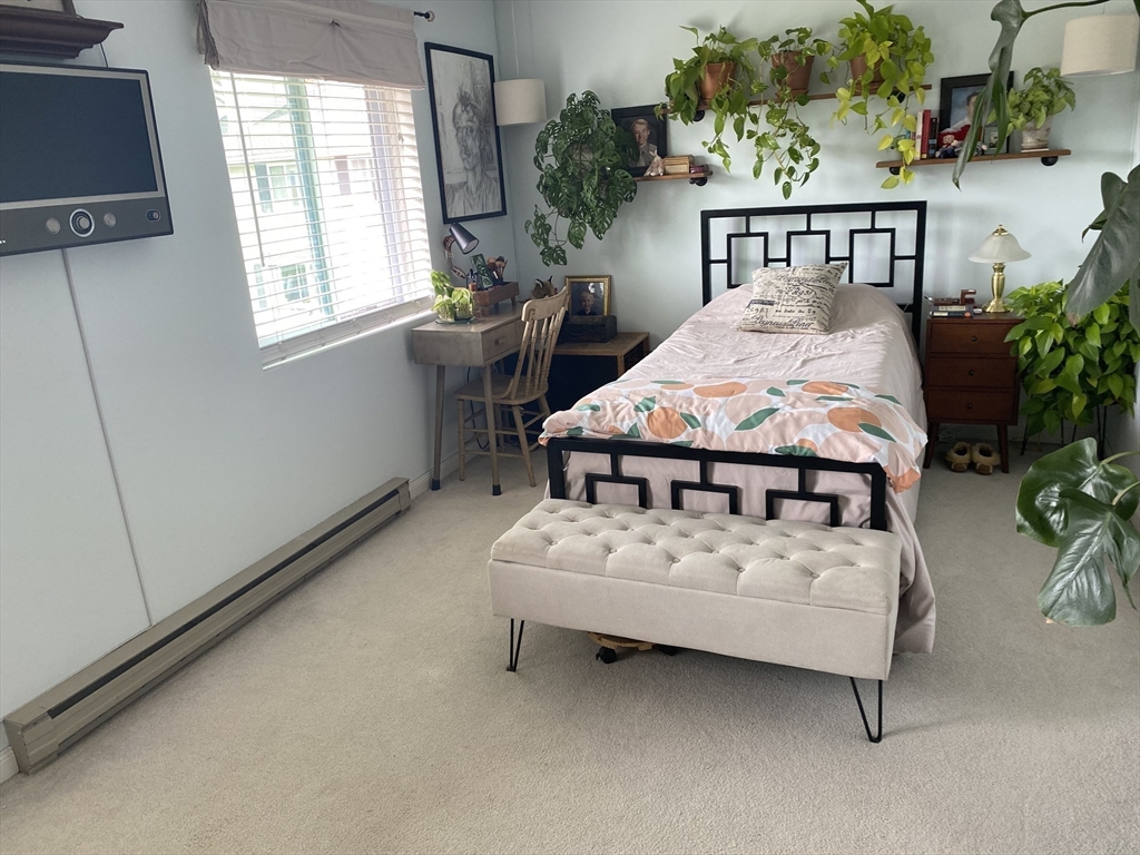 10 Erick Road, Unit 5 Mansfield, MA 02048 - Photo 8 of 24 a white bed sitting in a bedroom next to a window