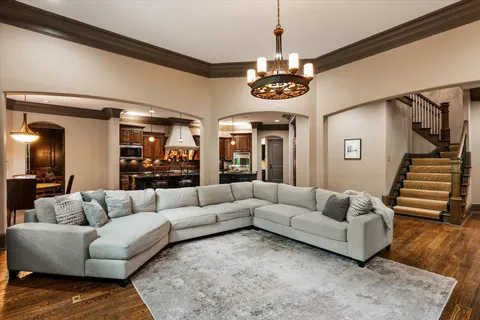 a living room with furniture a ceiling fan and a rug