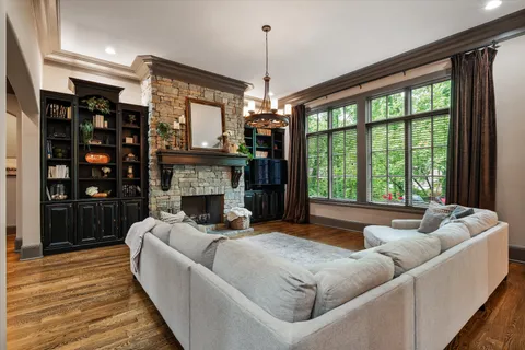 a bedroom with furniture and large windows