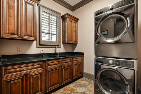 a bathroom with a granite countertop toilet sink shower and mirror