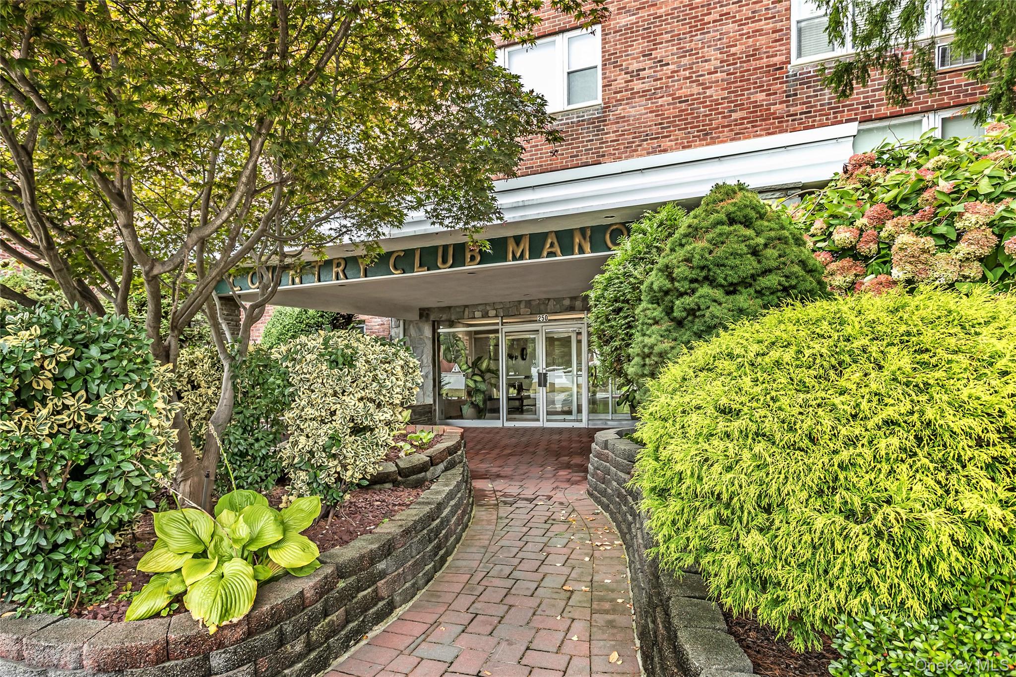 a view of a house with potted plants