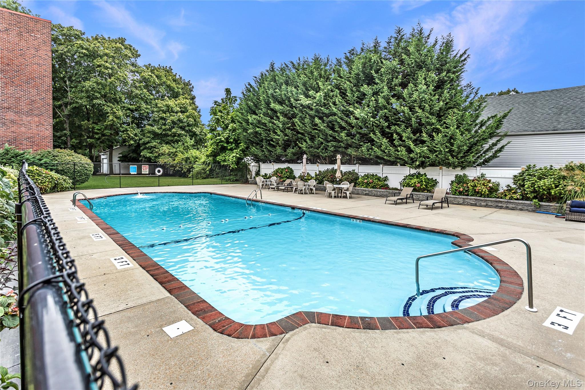 250 West Merrick Road, Unit 2L Freeport, NY 11520 - Photo 14 of 17 a view of a swimming pool with a patio