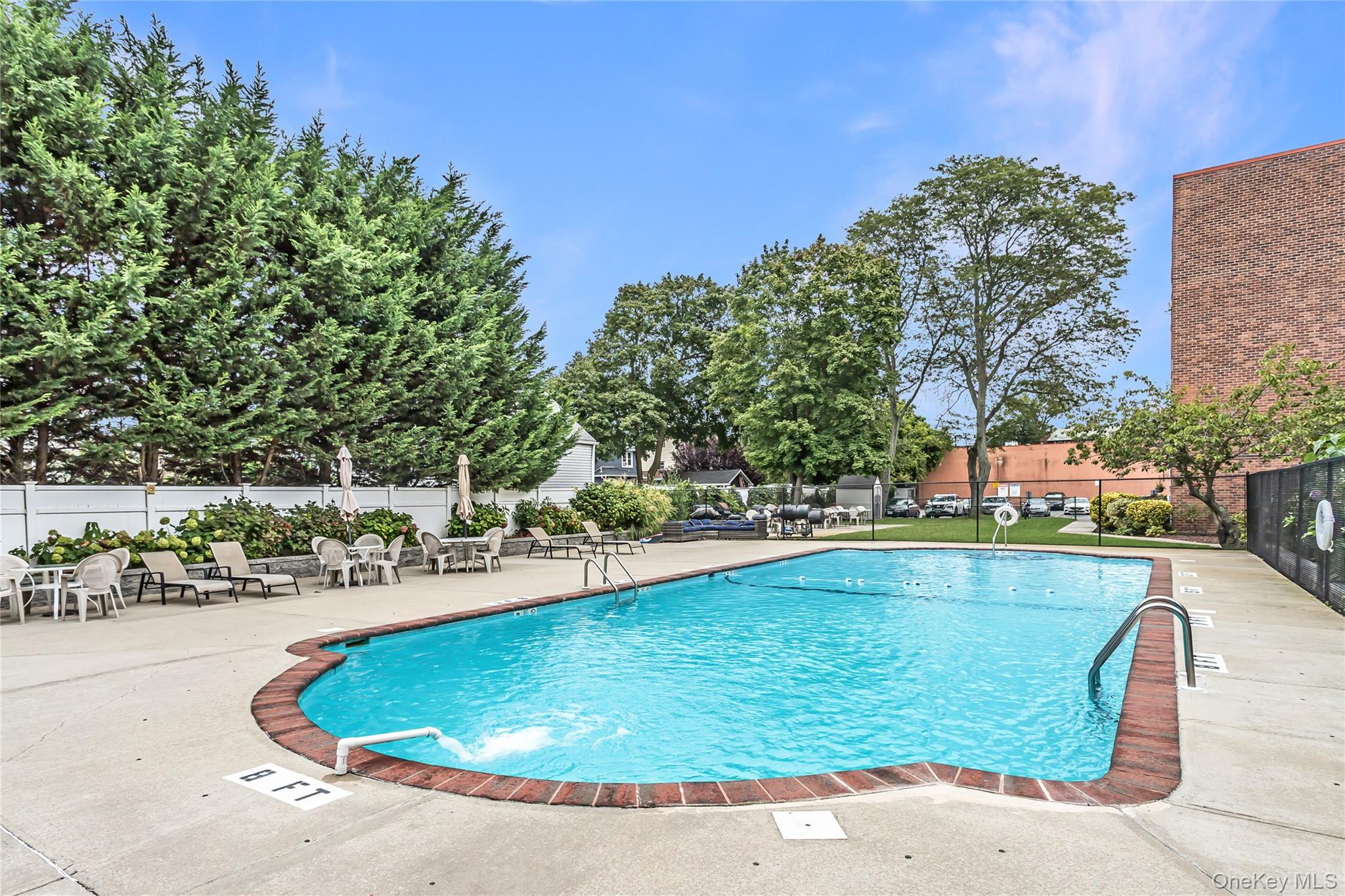 250 West Merrick Road, Unit 2L Freeport, NY 11520 - Photo 15 of 17 a view of a swimming pool with a patio