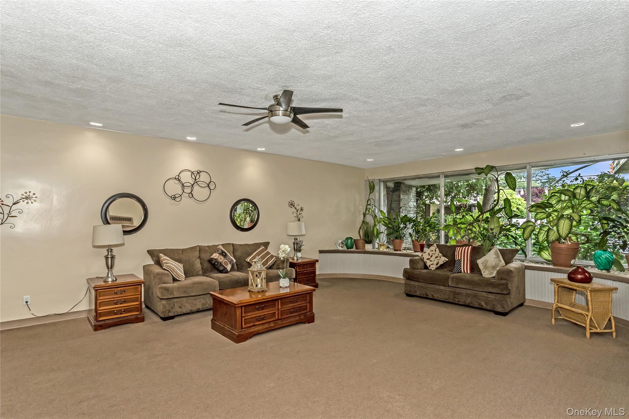 250 West Merrick Road, Unit 2L Freeport, NY 11520 - Photo 16 of 17 a living room with furniture and a clock