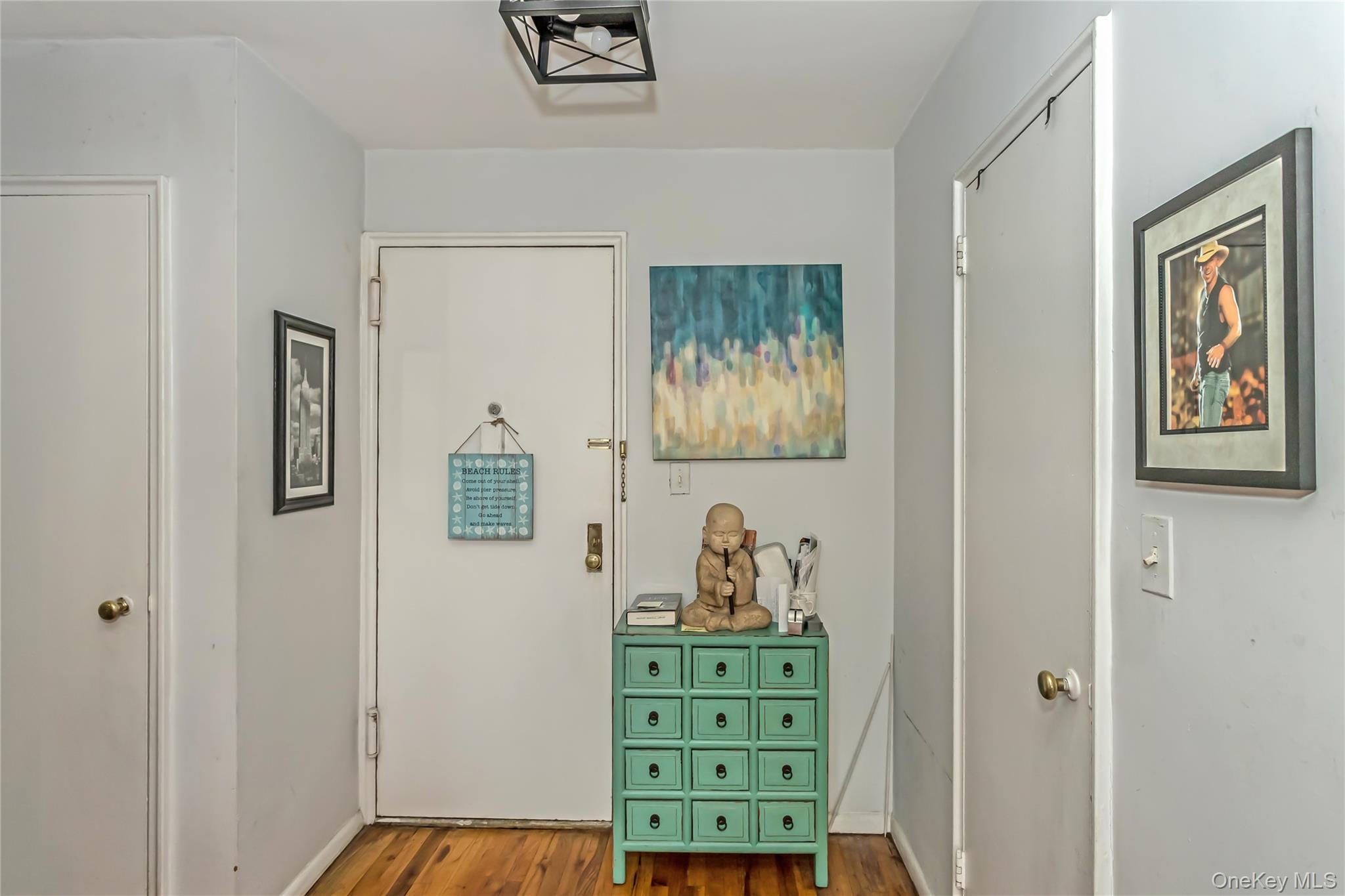 250 West Merrick Road, Unit 2L Freeport, NY 11520 - Photo 3 of 17 a view of bedroom with furniture and wooden floor