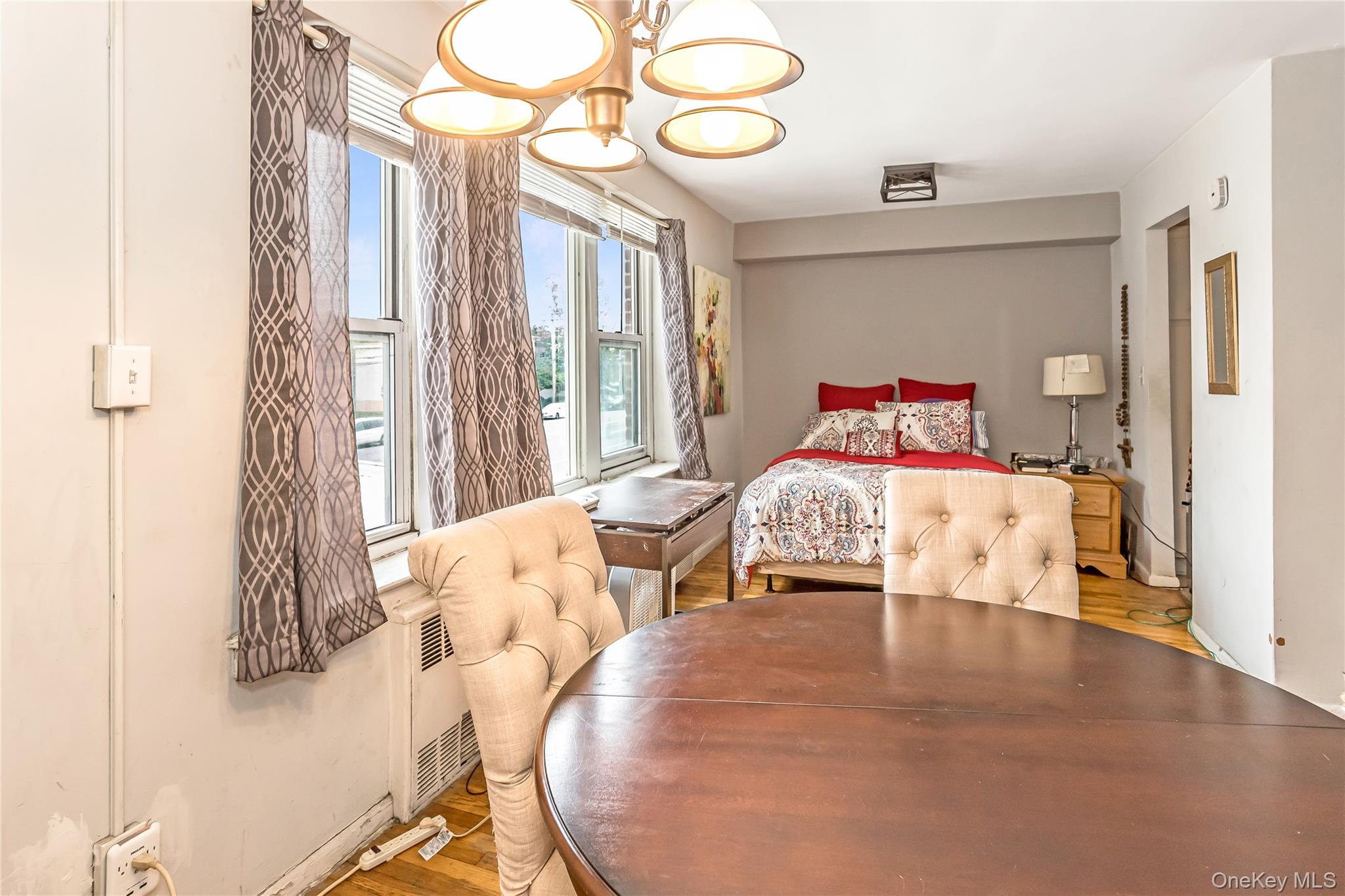 250 West Merrick Road, Unit 2L Freeport, NY 11520 - Photo 6 of 17 a bedroom with a bed and wooden floor