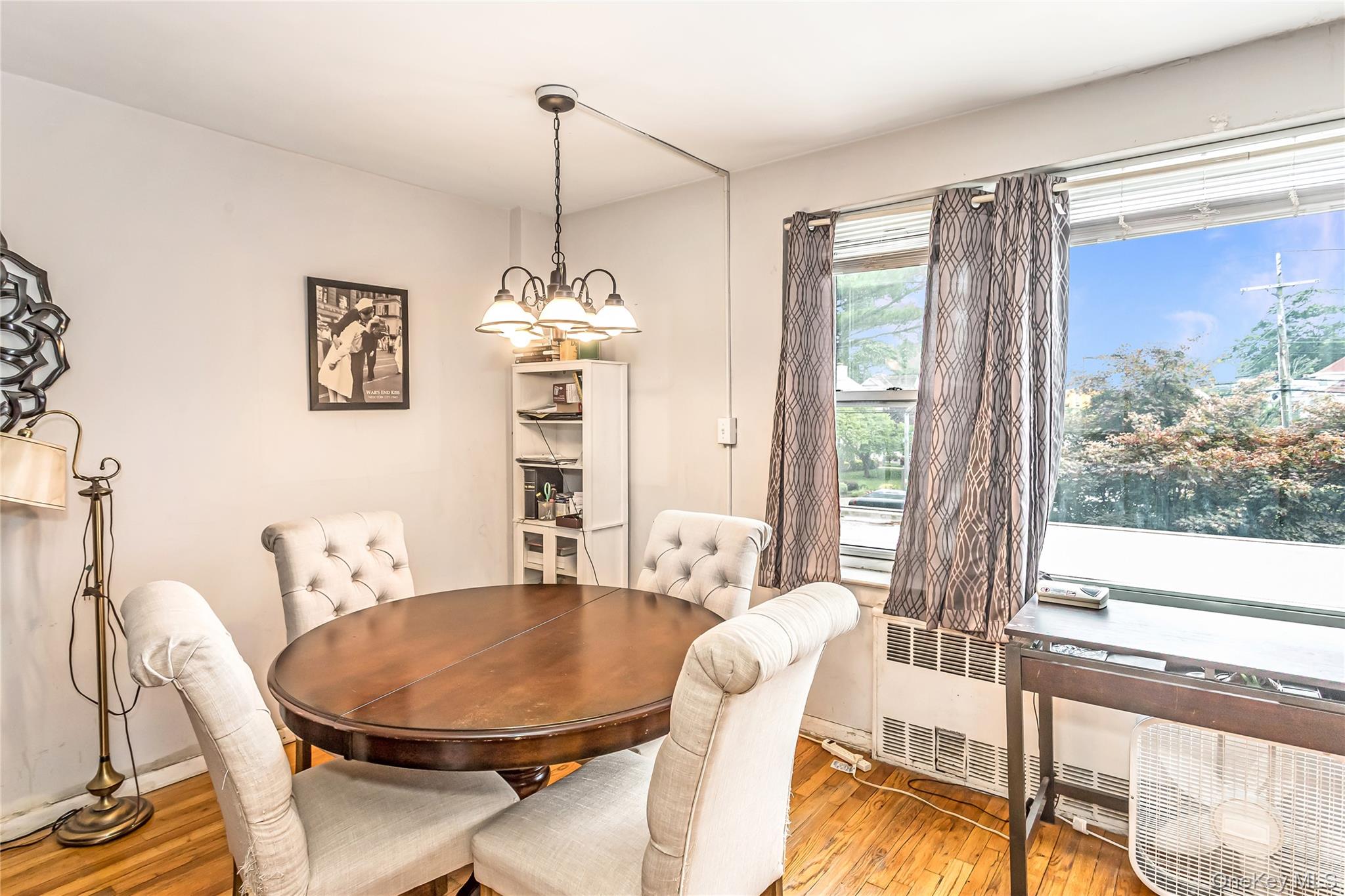 250 West Merrick Road, Unit 2L Freeport, NY 11520 - Photo 7 of 17 a living room with furniture a table and a large window