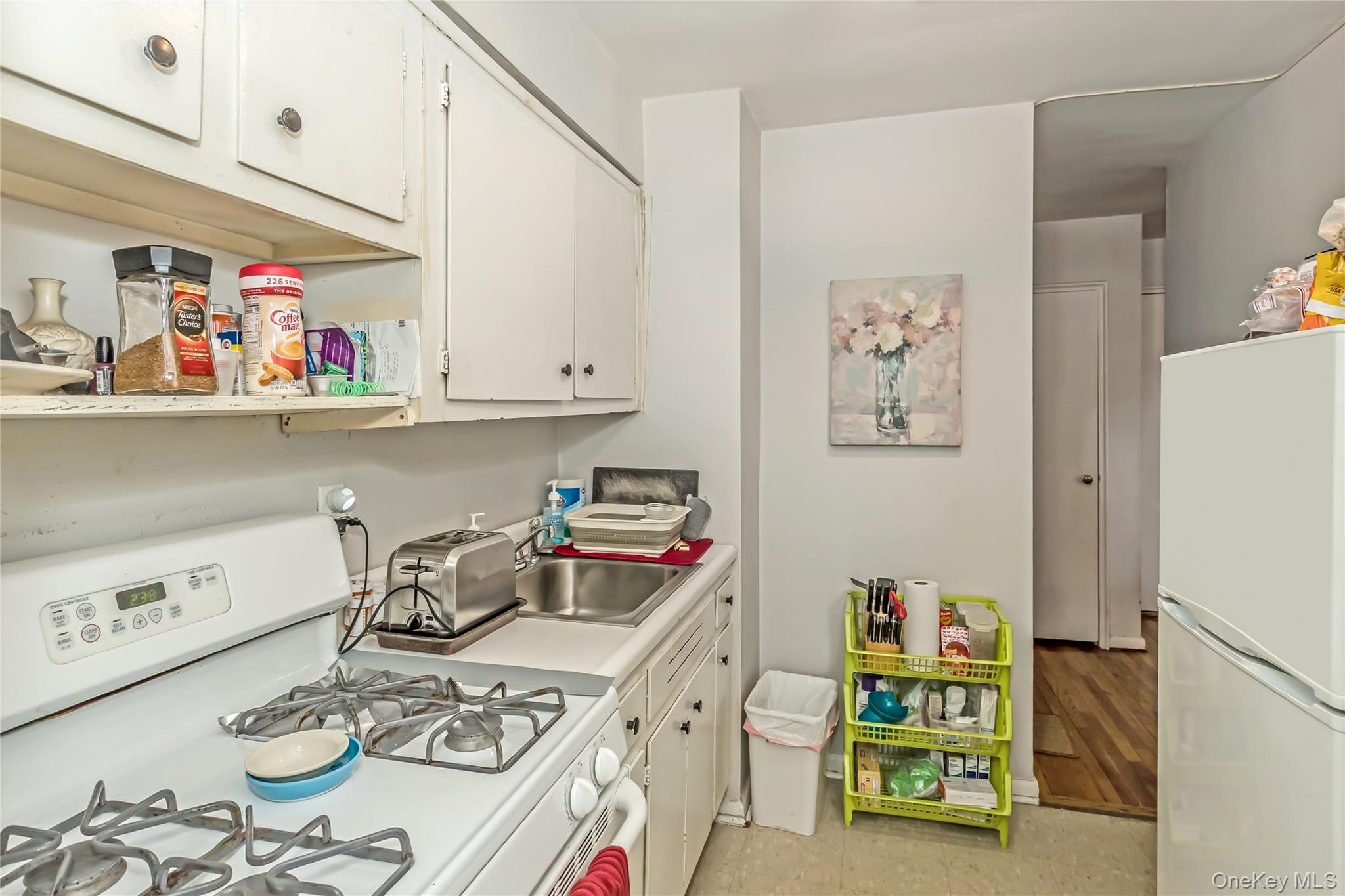250 West Merrick Road, Unit 2L Freeport, NY 11520 - Photo 8 of 17 a kitchen with stainless steel appliances granite countertop a table and chairs in it