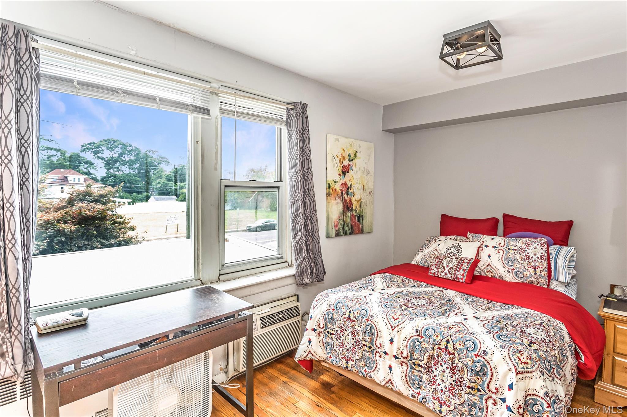 250 West Merrick Road, Unit 2L Freeport, NY 11520 - Photo 10 of 17 a bedroom with a bed and a window
