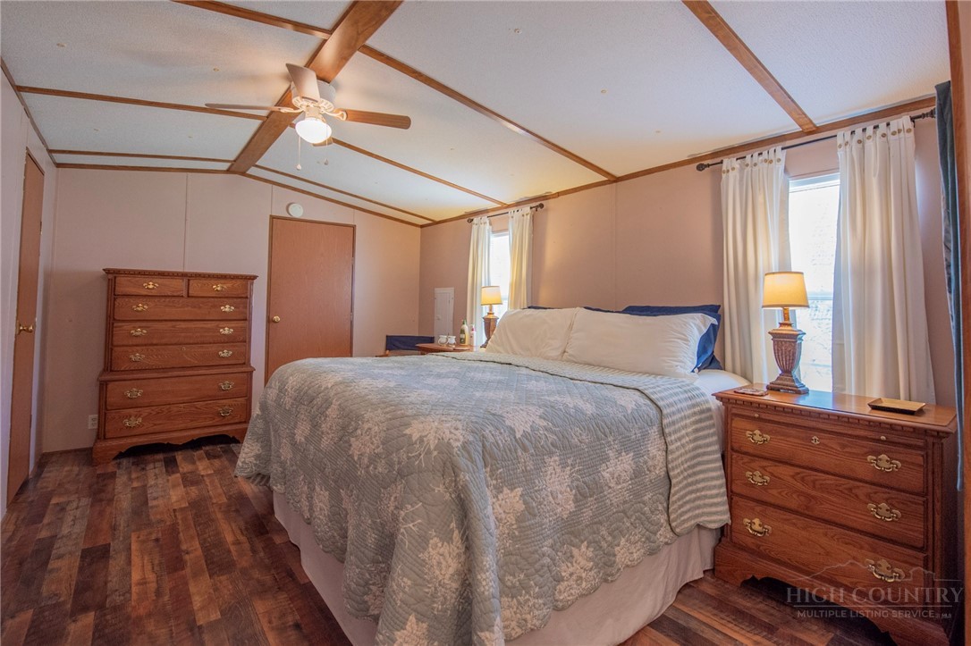 1848 West Mill Creek Road Warrensville, NC 28693 - Photo 29 of 50 a bedroom with a bed and a mirror on the dresser