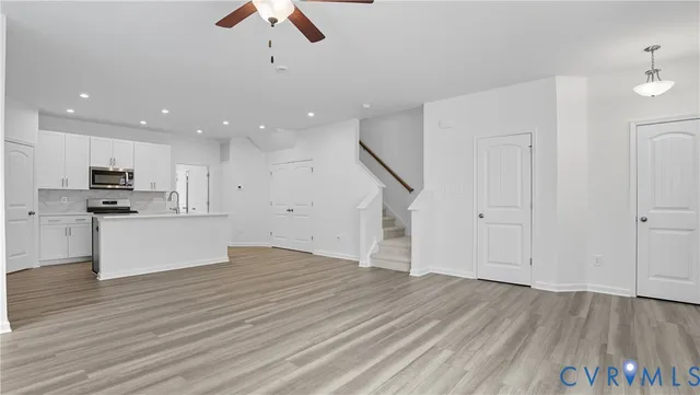 a view of kitchen with granite countertop cabinets and wooden floor