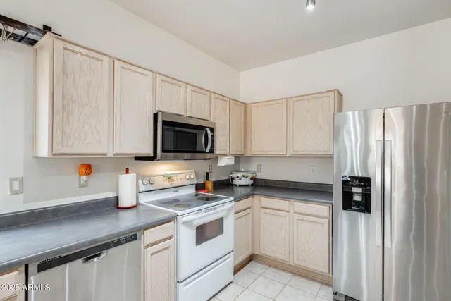 a kitchen with a sink appliances and cabinets