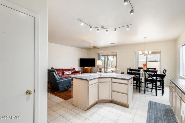 a kitchen with stainless steel appliances granite countertop a sink a stove a refrigerator and cabinets