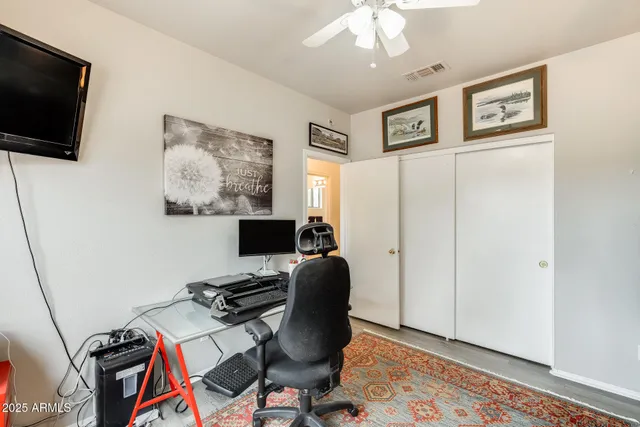 a view of a workspace with furniture and a window
