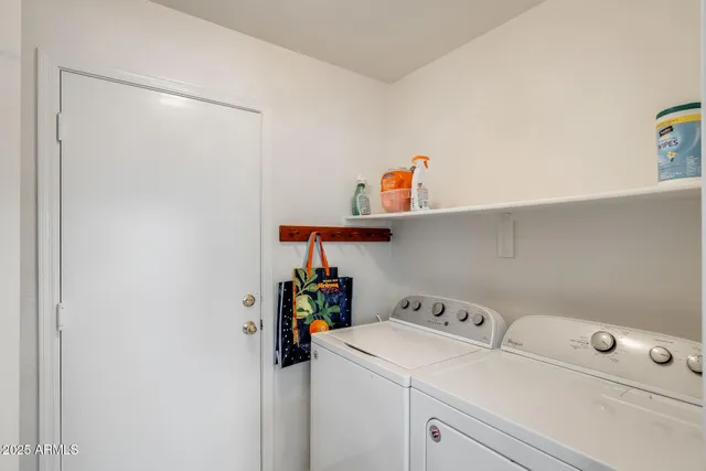 a view of walk in closet with clothes